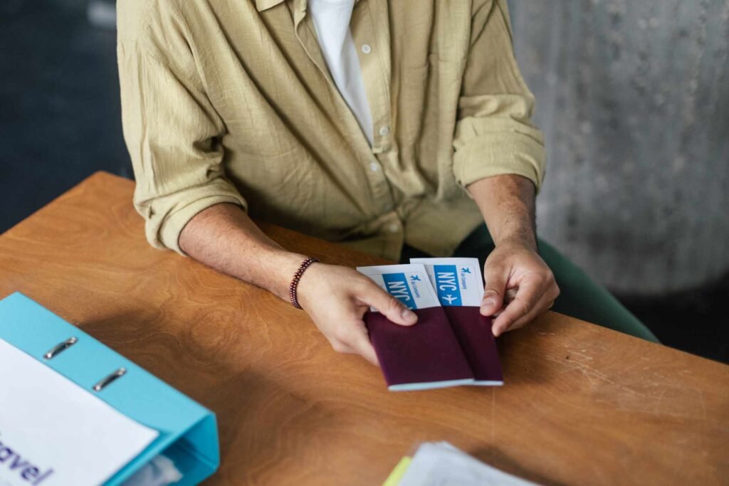 close-up-of-young-woman-holding-plane-tickets-JNZCC5D.jpg